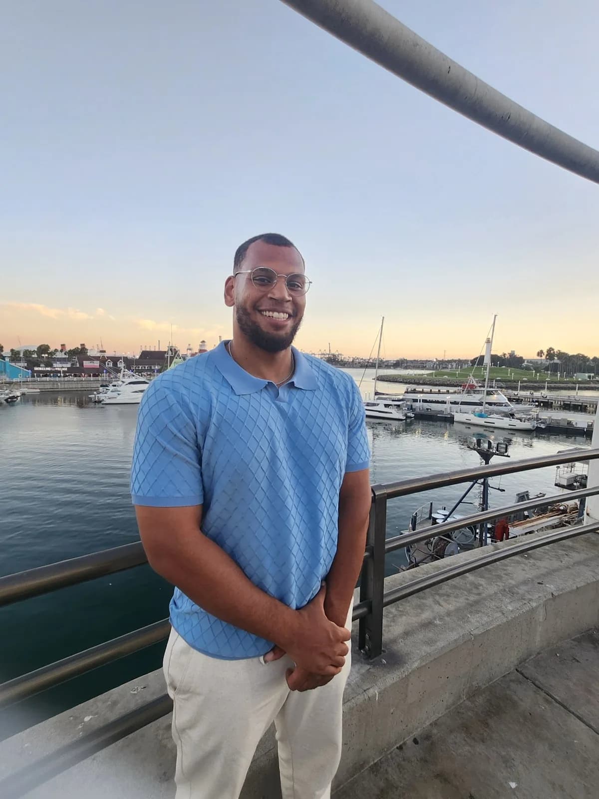 TG at a waterfront at sunset